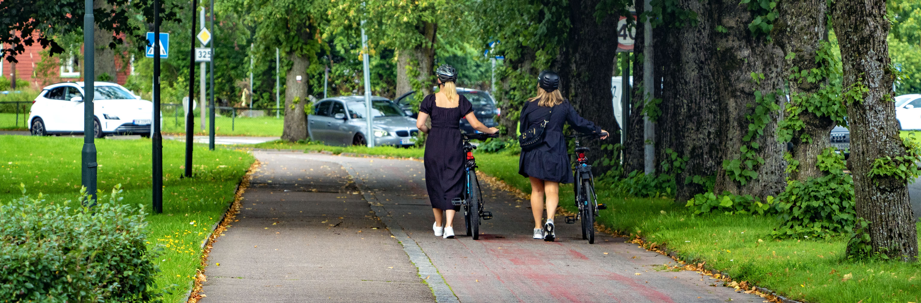 To kvinner går med sykkel langs sykkelvei i Tønsberg sentrum
