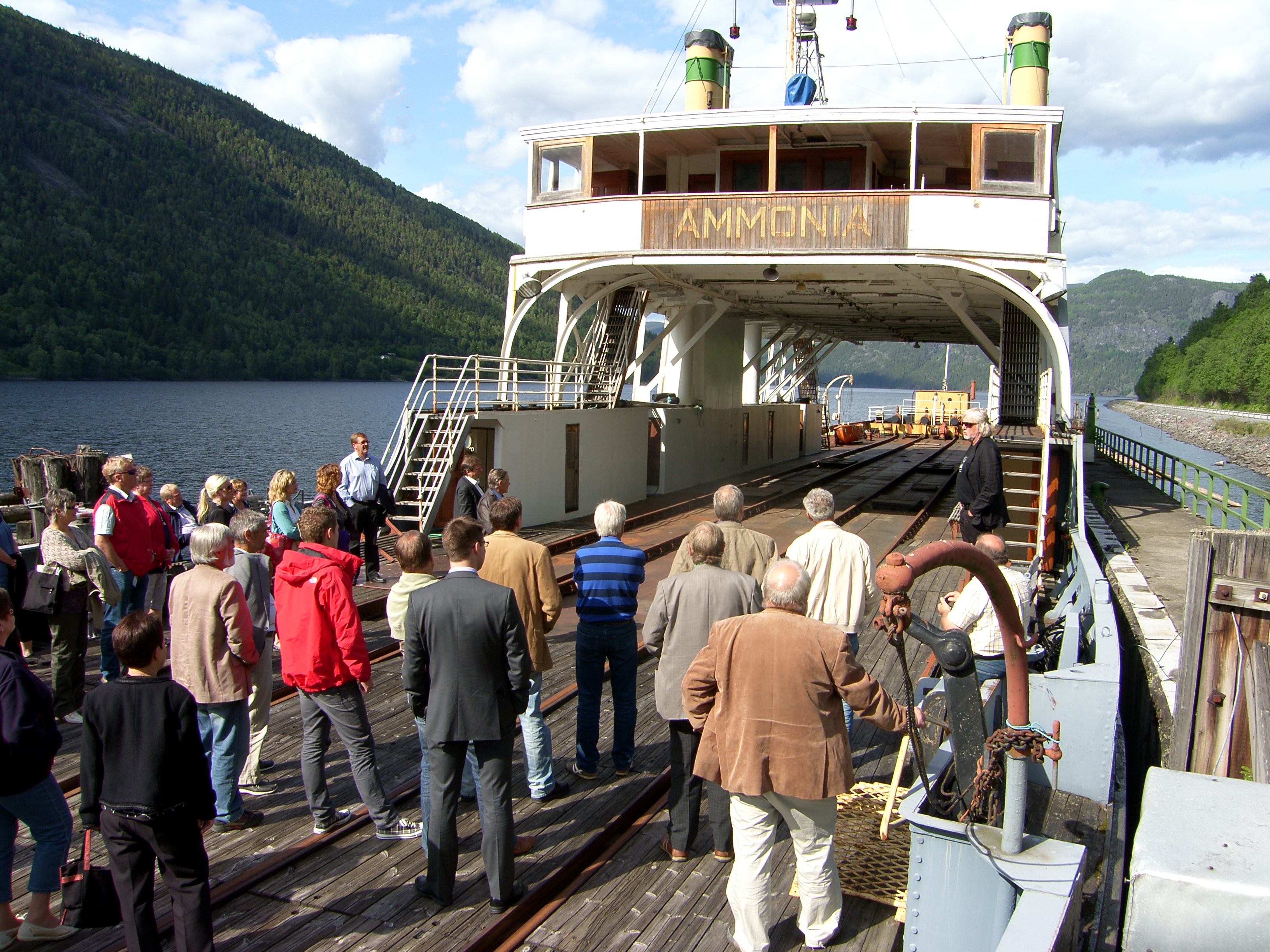 Gammel ferge med en gruppe mennesker på dekk