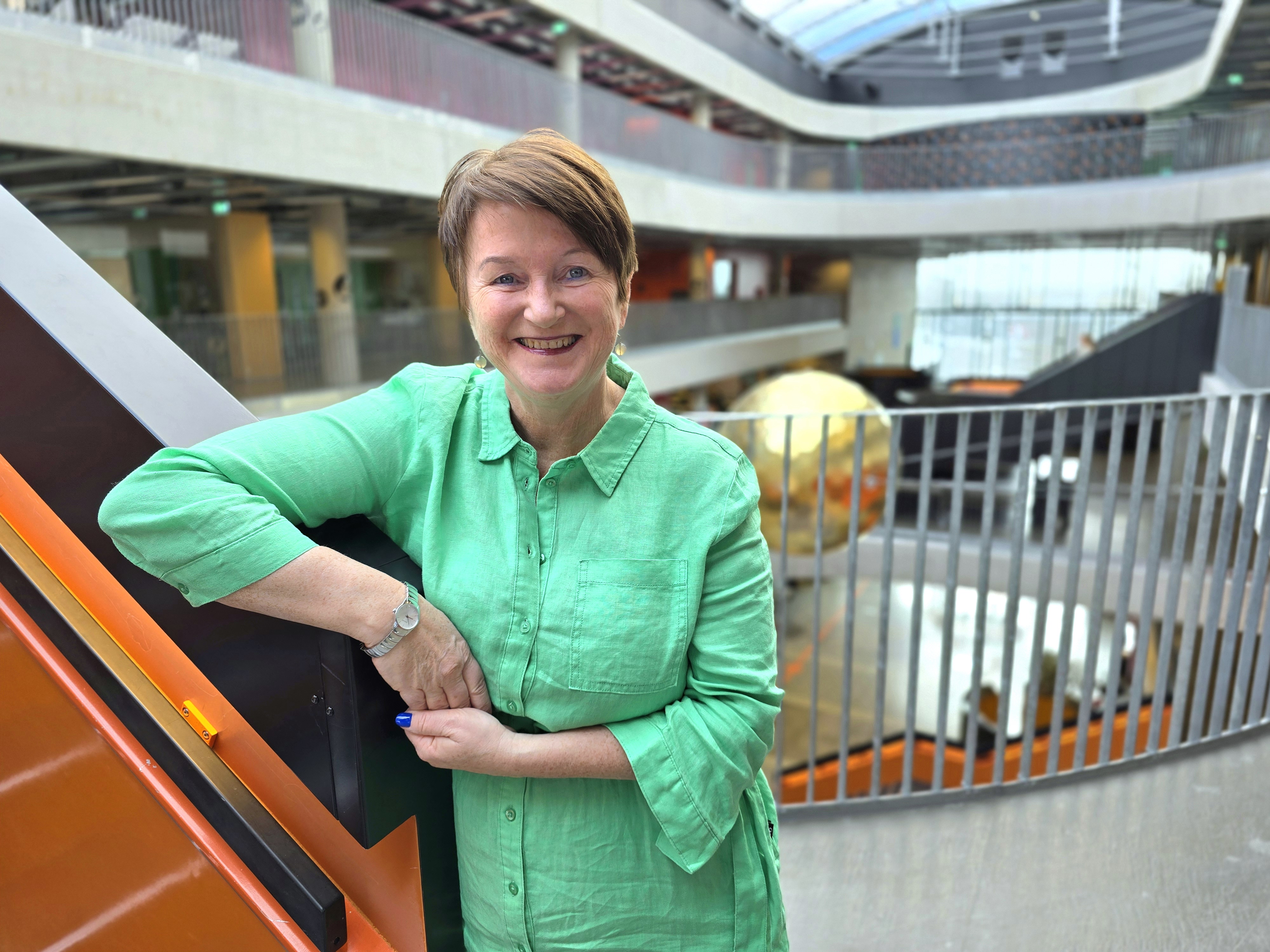 Rektor på skolen, lener seg til trapp.